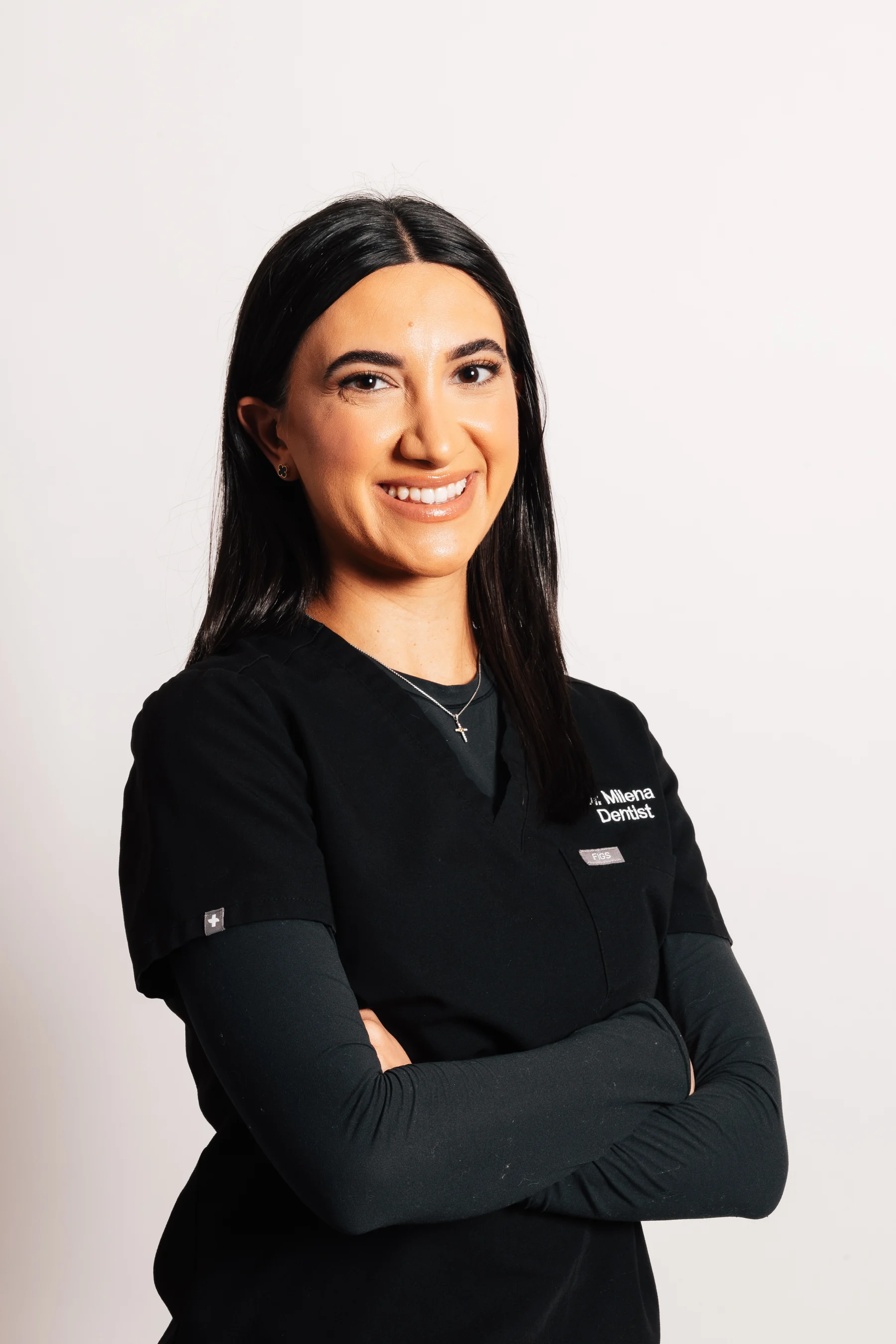 Dr. Milena Arakelyan, DMD, standing with arms crossed
